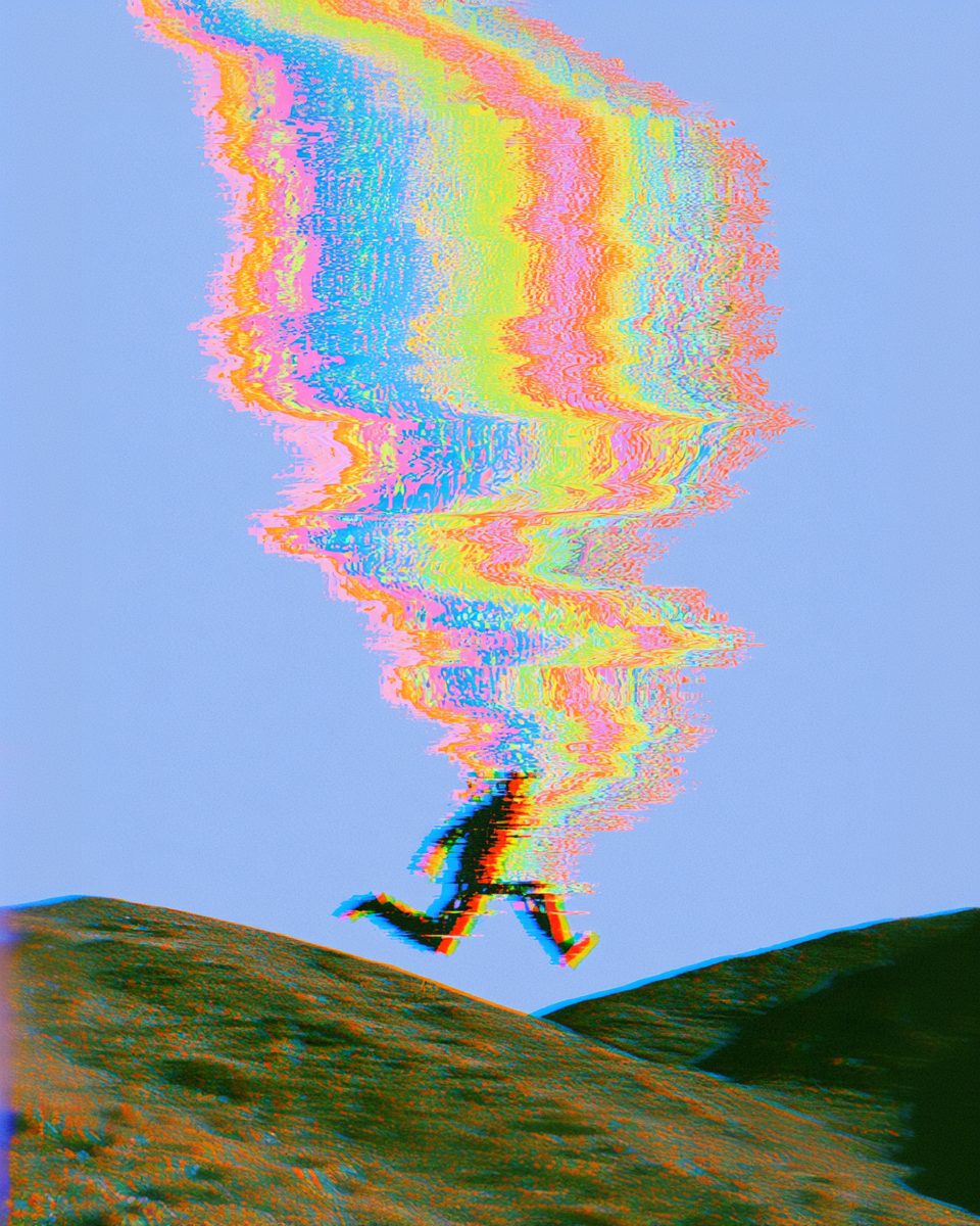 A figure leaping across a hillside, trailing a plume of colour