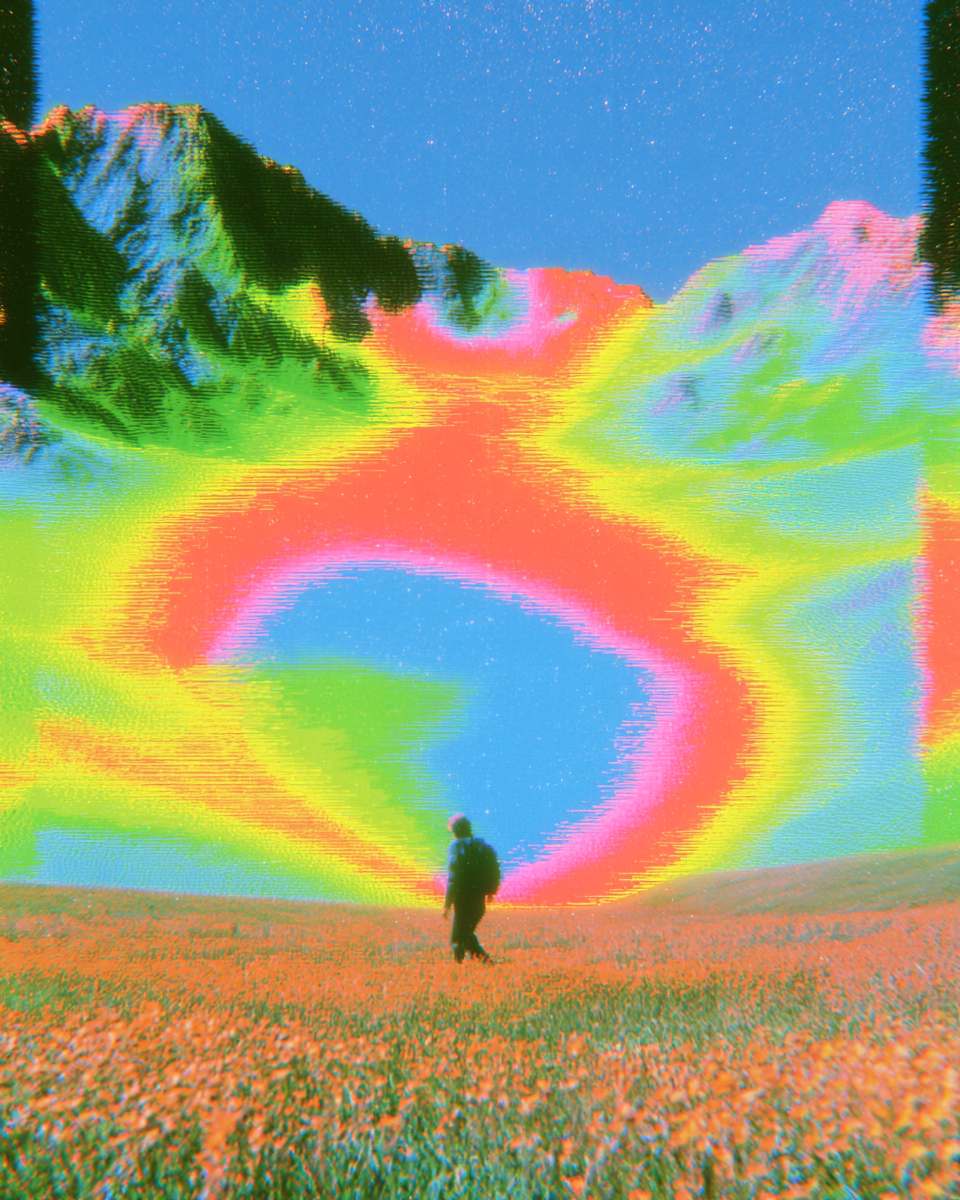 A lone figure walking a field toward banded hills
