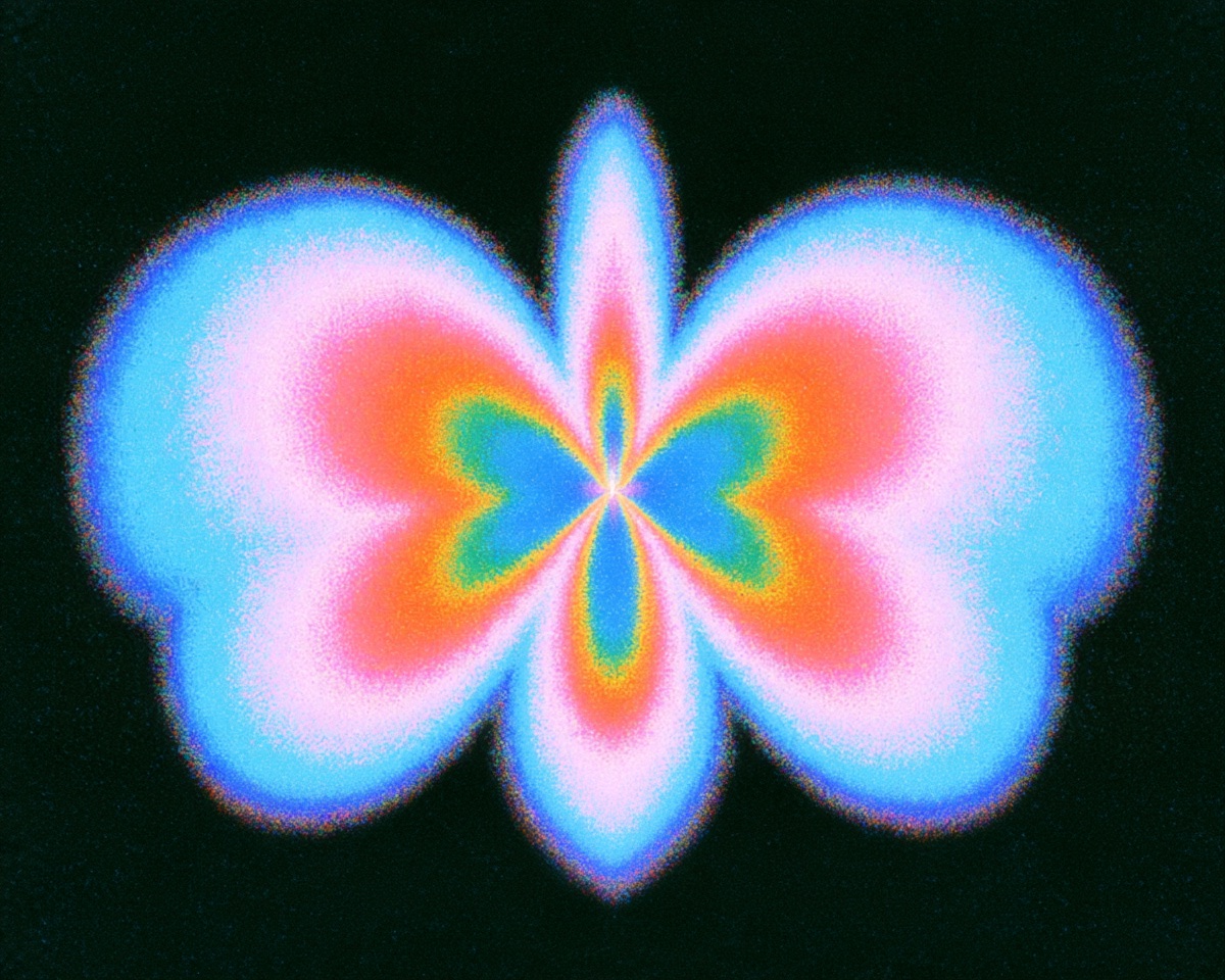 A luminous, heart-like shape in blue, pink and gold against a dark background.